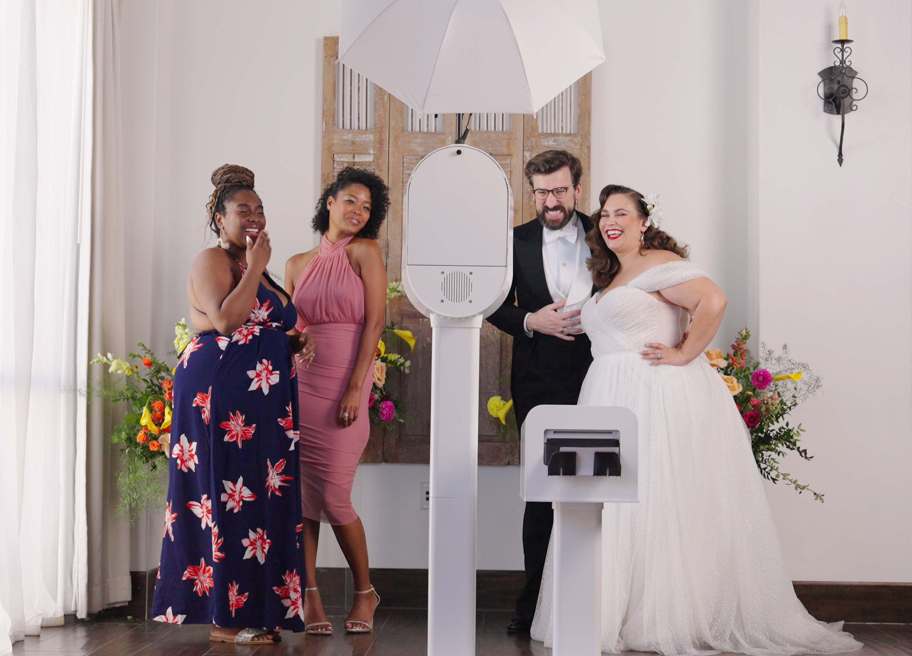 Bridal party reacting at the booth