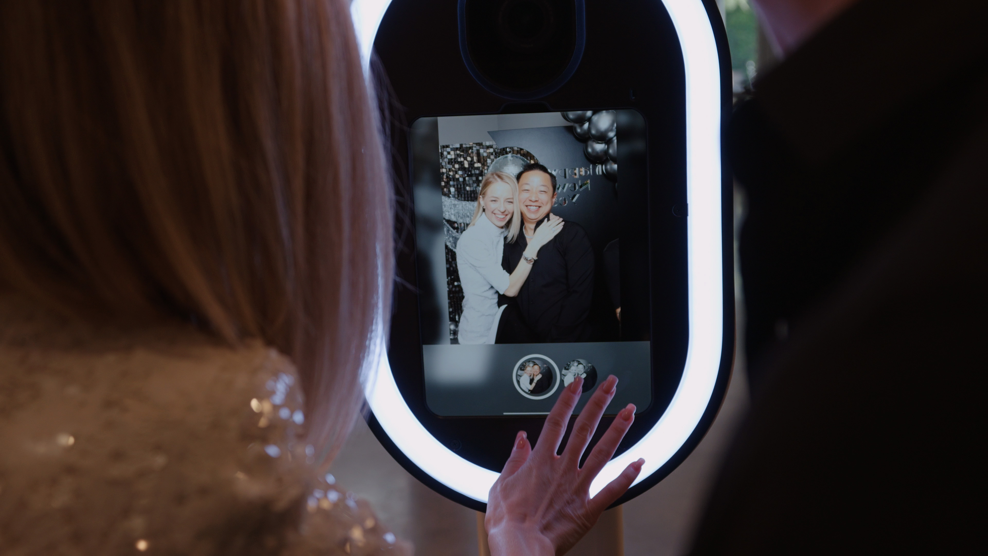 Couple posing in the booth screen